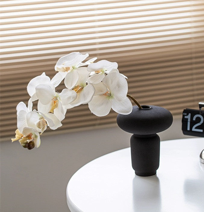Mushroom shaped ceramic vase used for a flower arrangement