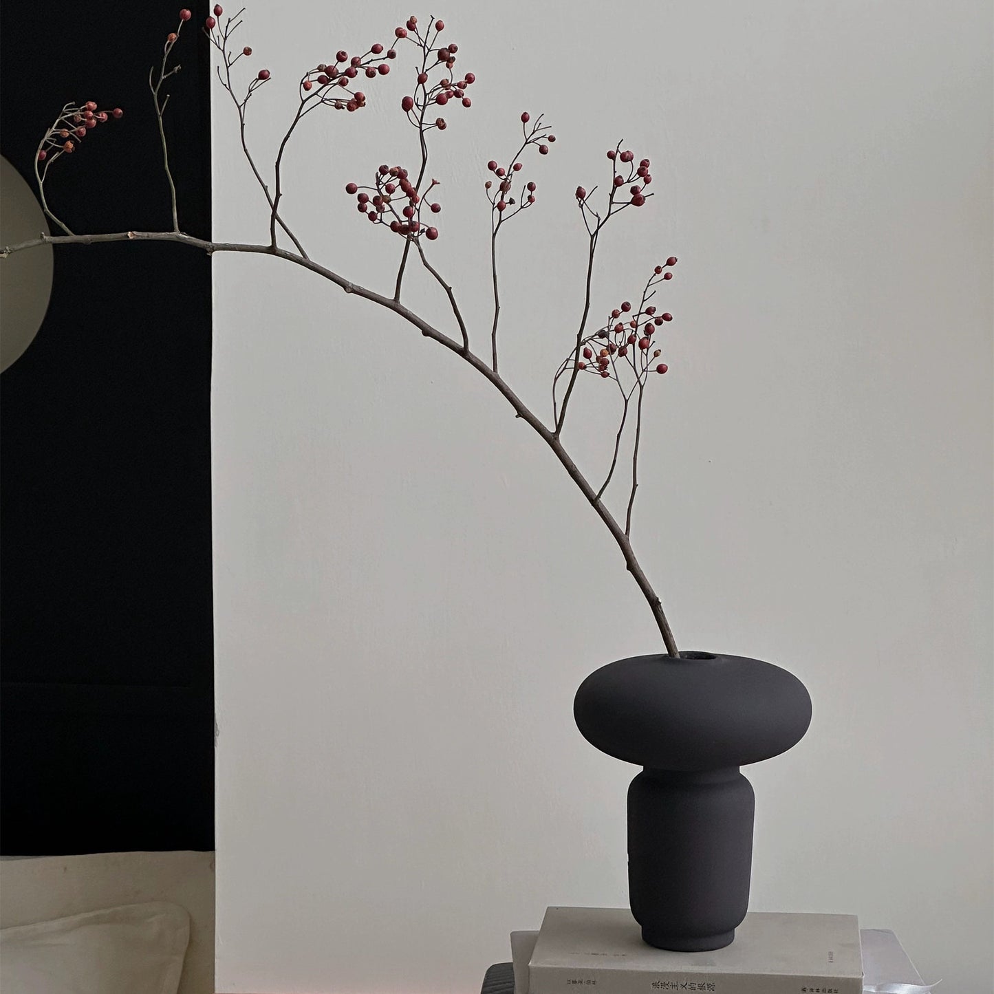 Mushroom shaped ceramic vase displayed with decorative branches