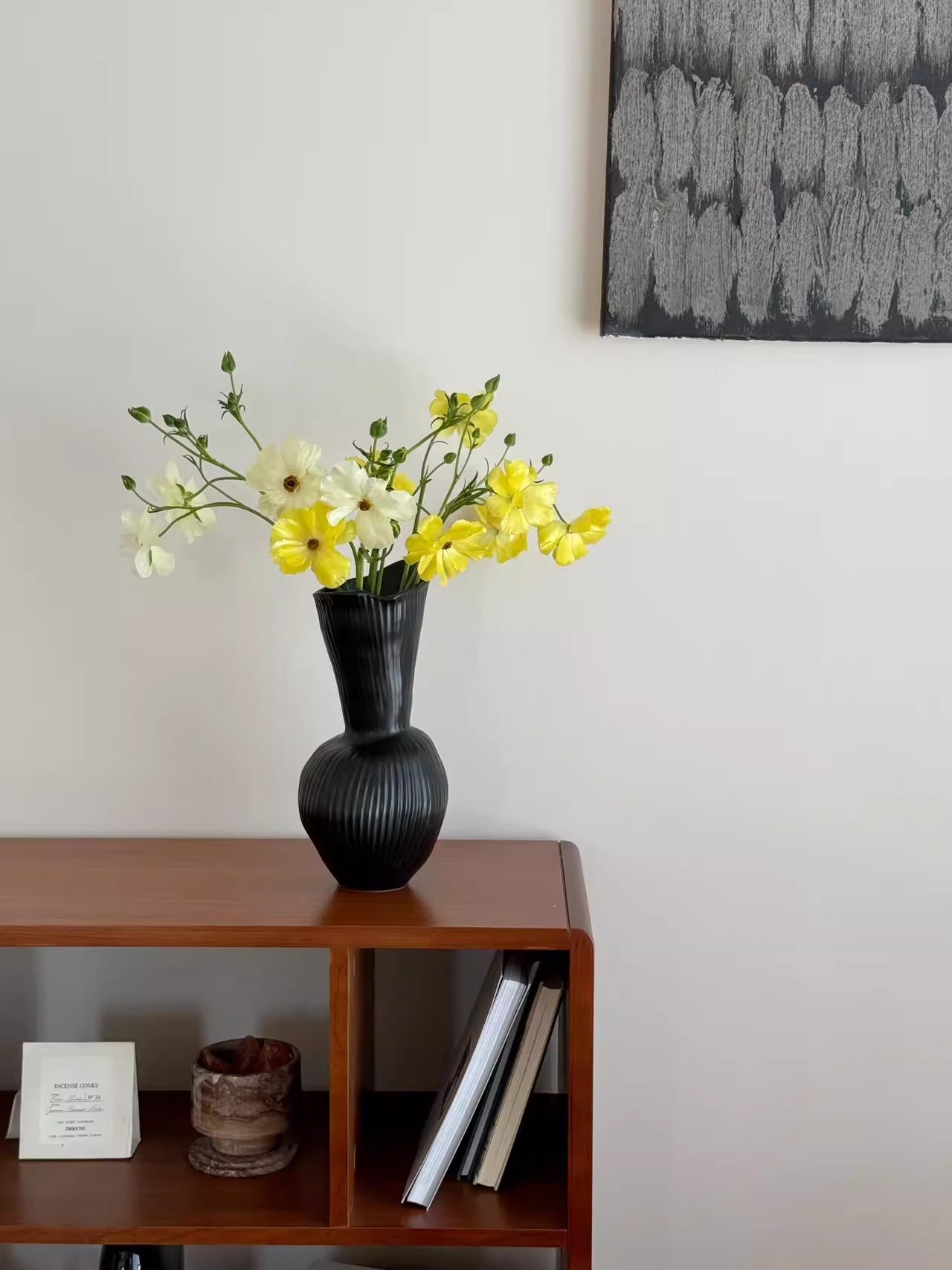 Ribbed gourd ceramic vase displayed on a console table