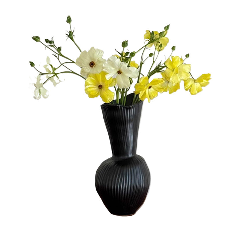 Ribbed gourd ceramic vase with a flower arrangement