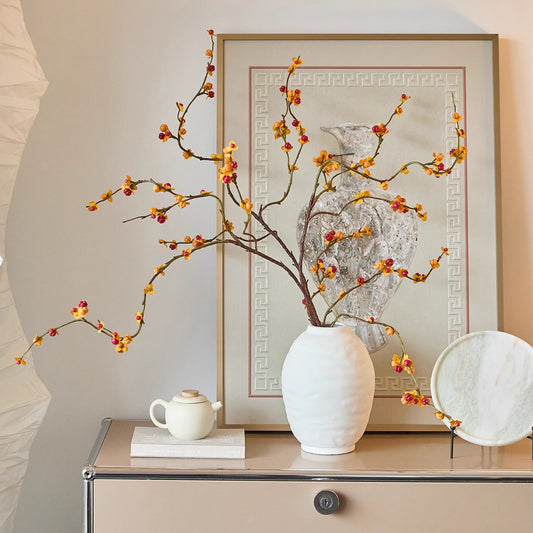 Ridged oval ceramic vase displayed on a cabinet