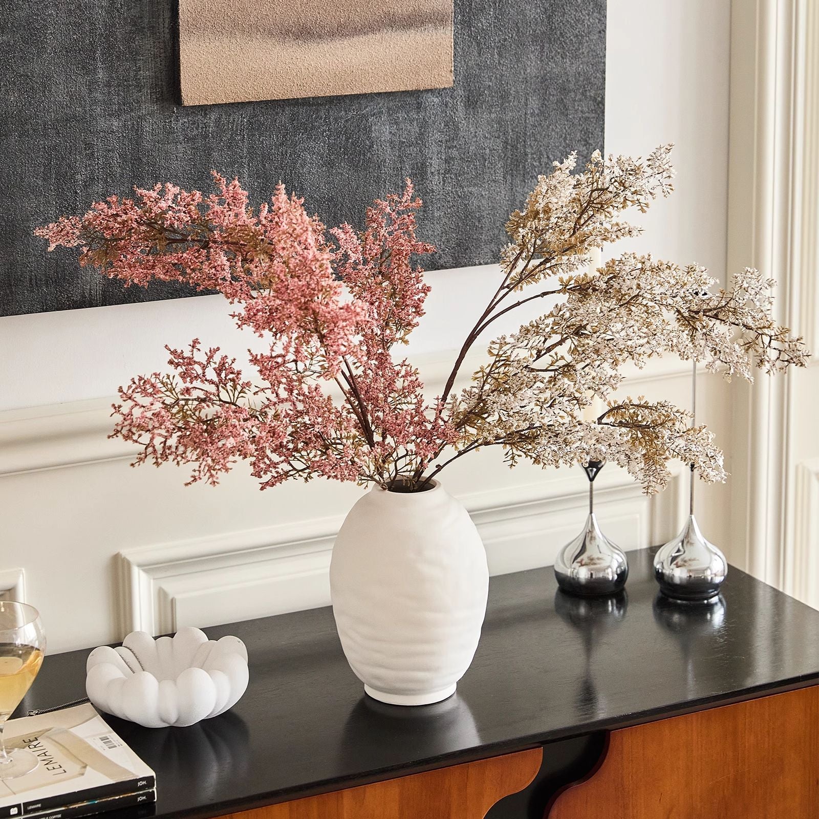 Ridged oval ceramic vase displayed with decorative branches