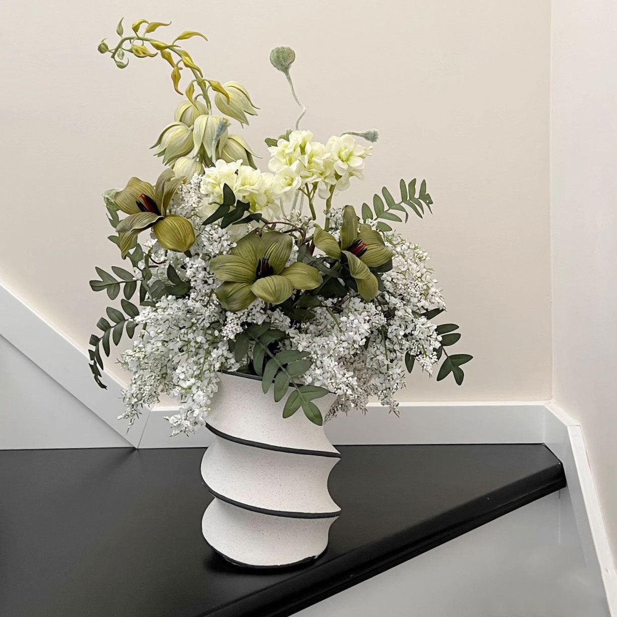 Spiral ceramic decorative vase displayed on a table