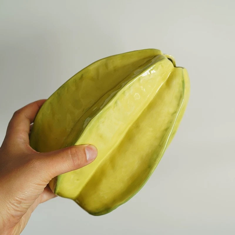 Star fruit shaped ceramic vase shown from a handheld view