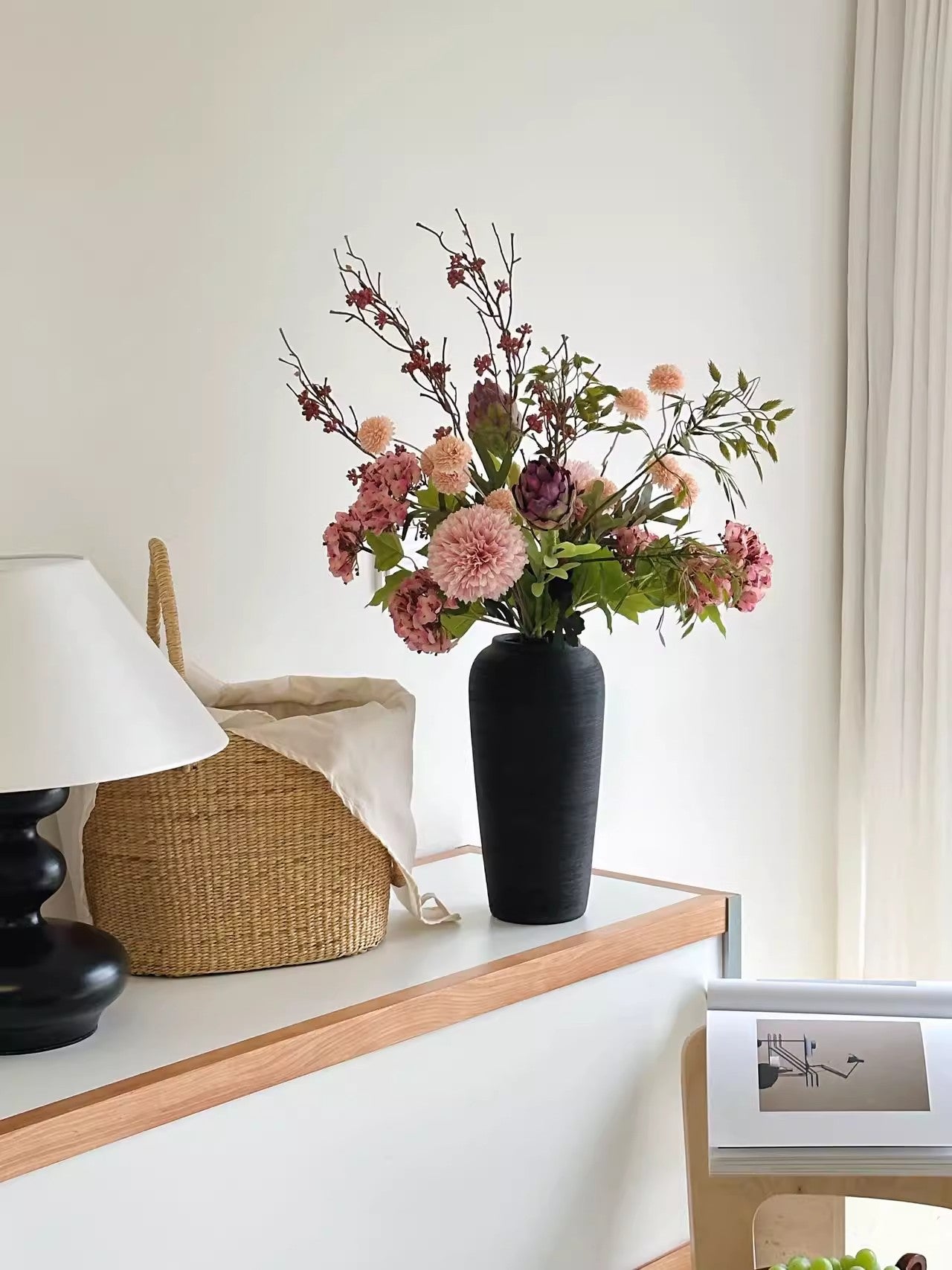 Tall textured ceramic vase displayed in a room