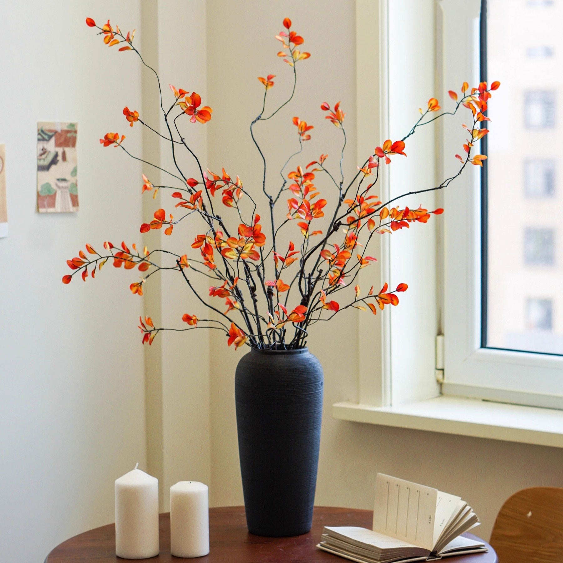 Textured tall ceramic vase displayed near a window